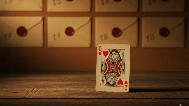 Queen of Hearts card in front of a board of numbered envelopes